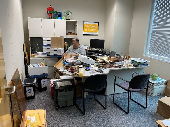 An image of George packing up his old office.