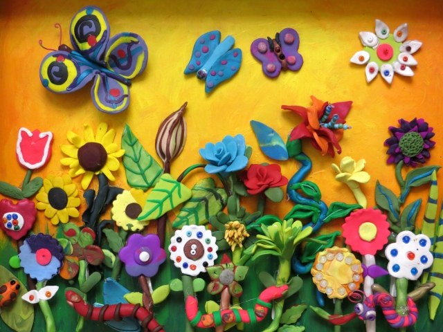image of clay garder with flowers and butterflies