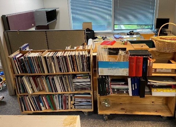 A picture of moving carts loaded with books, folders, and other items.